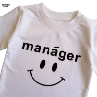 تیشرت بلوز استین بلند نخی سفید بچگانه با چاپ نوشته Manager و طرح اسمایل زیر کت